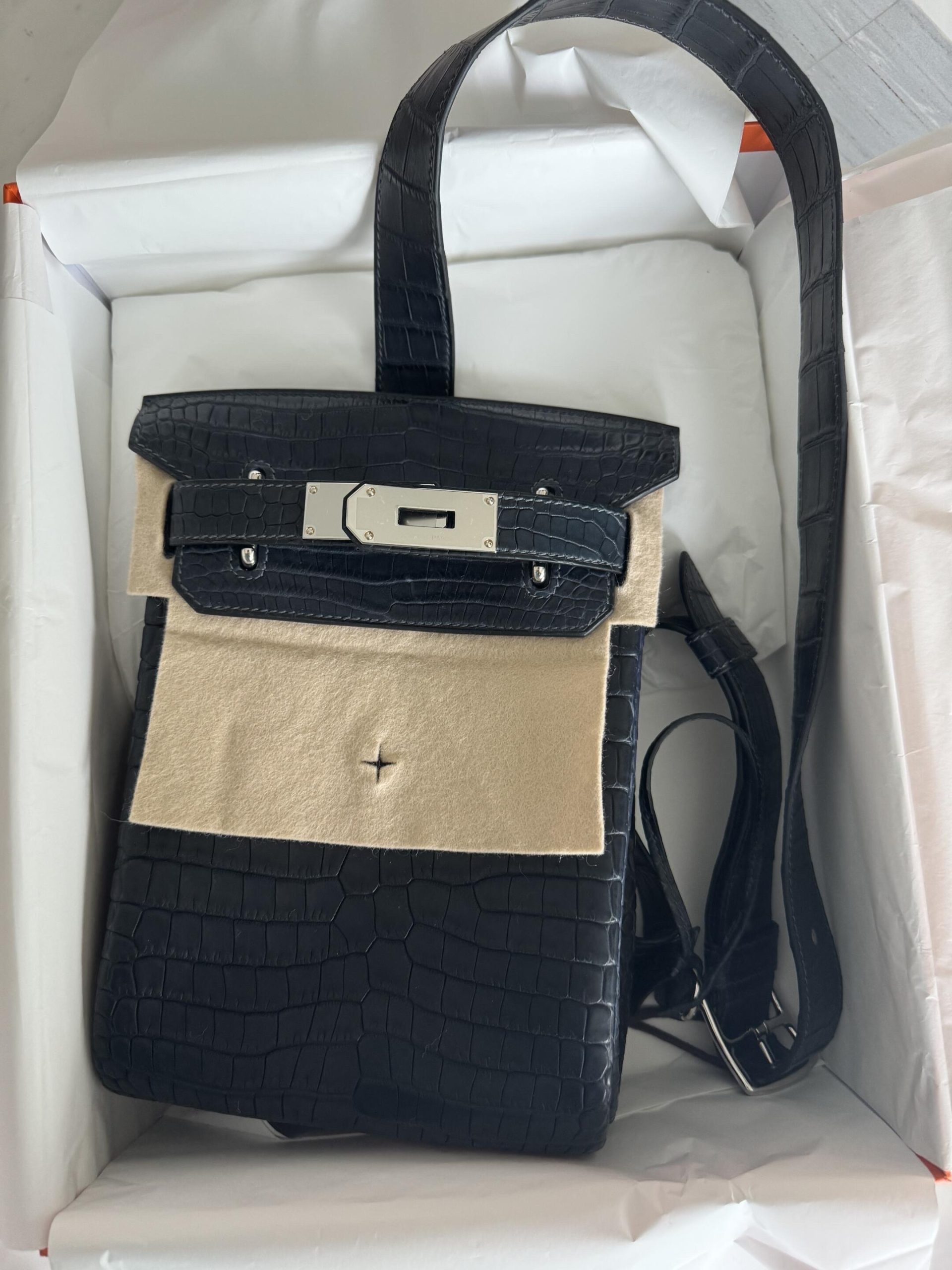 A buyer's unboxing photo of the Matte Niloticus Crocodile HAC a Dos PM in its original orange box