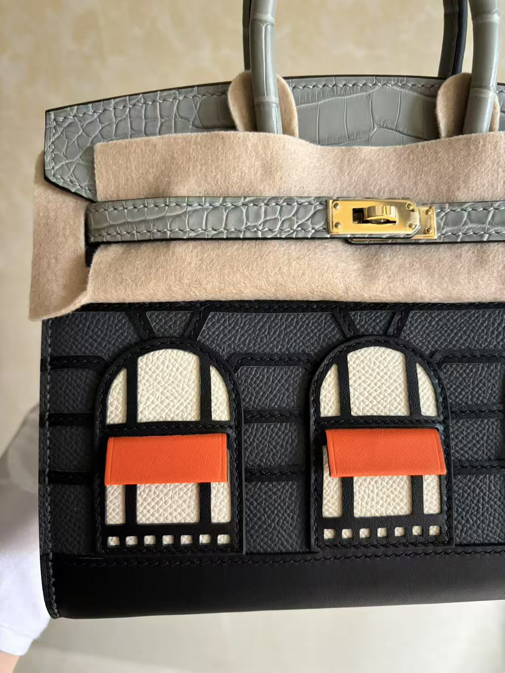 A micro close-up of the left side of the Faubourg Birkin facade