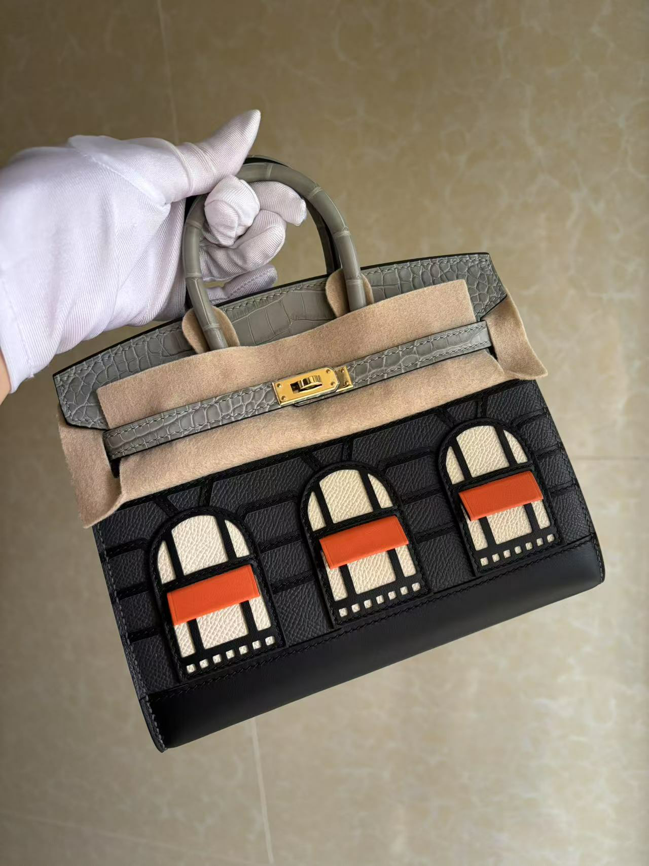 A full hand-held angled view of the locked Faubourg Birkin Rainy Day