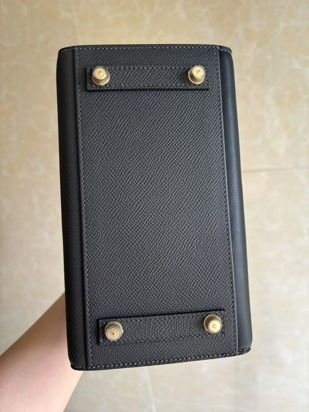 The bottom view of the Hermes Faubourg Birkin 20, displaying the four protective feet