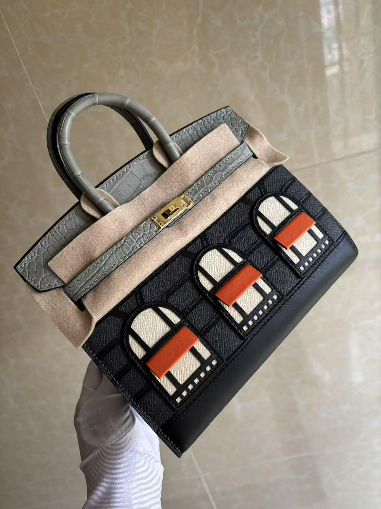 An angled view of the held Hermes Faubourg Birkin 20 Rainy Day