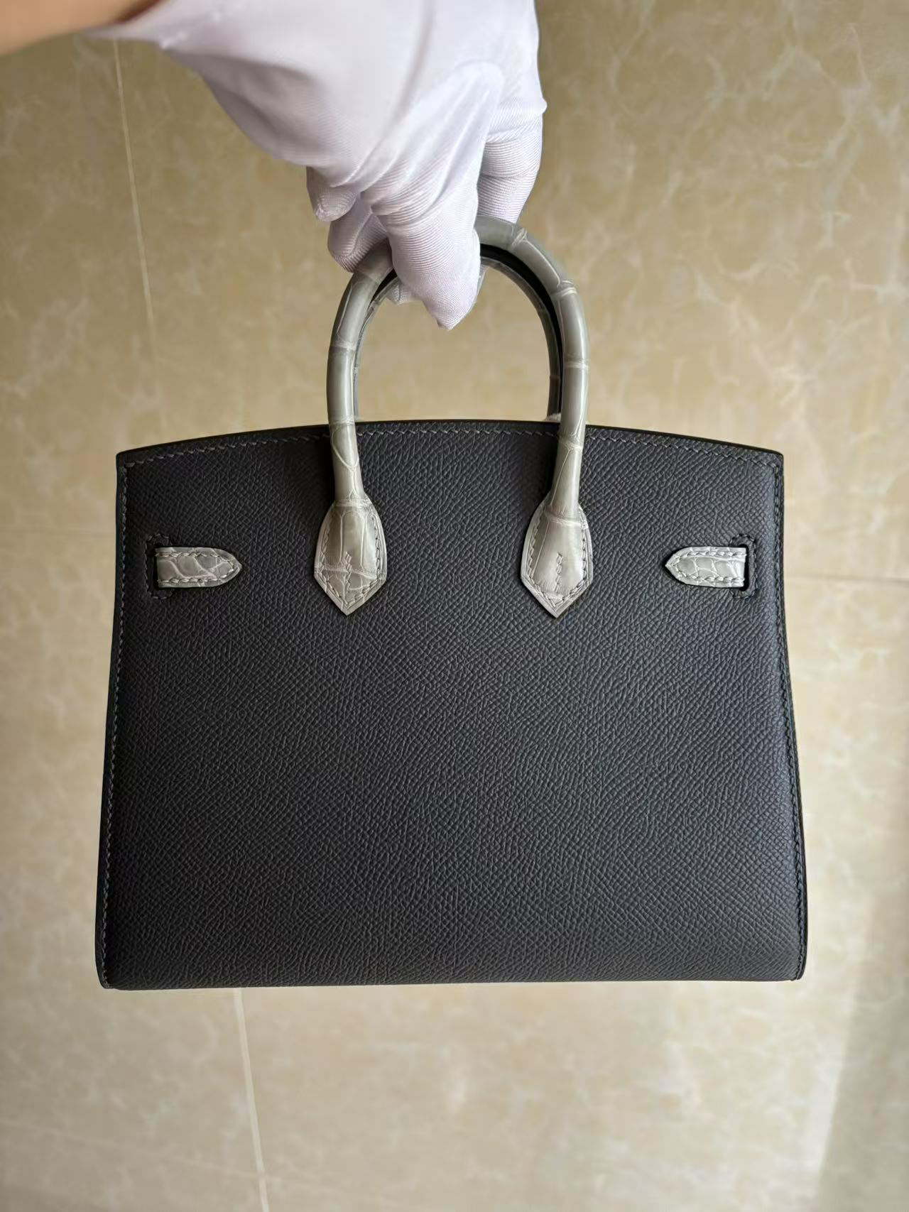 The back view of the Hermes Faubourg Birkin 20 Rainy Day, showing the clean Gris Misty Epsom leather body