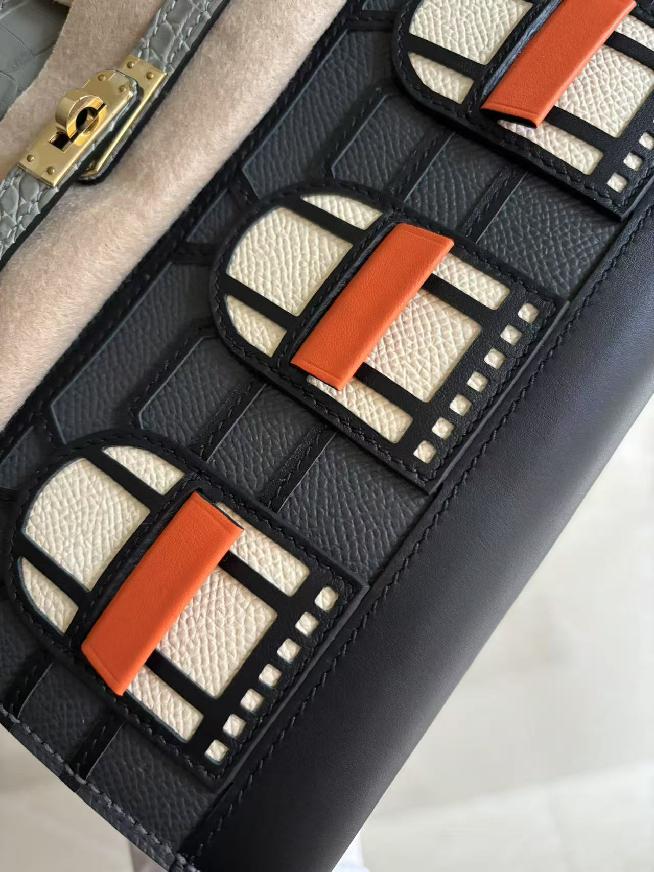 The detailed architectural facade of the Hermes Faubourg Birkin 20 Rainy Day