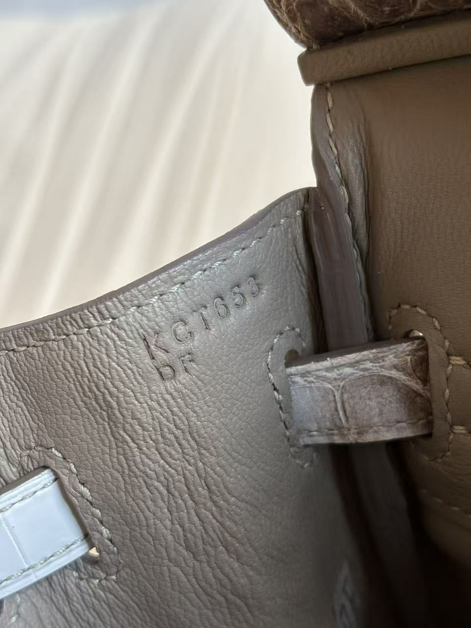 Macro view of the Blind Stamp tucked discreetly inside the left-side flap of a Himalayan Birkin