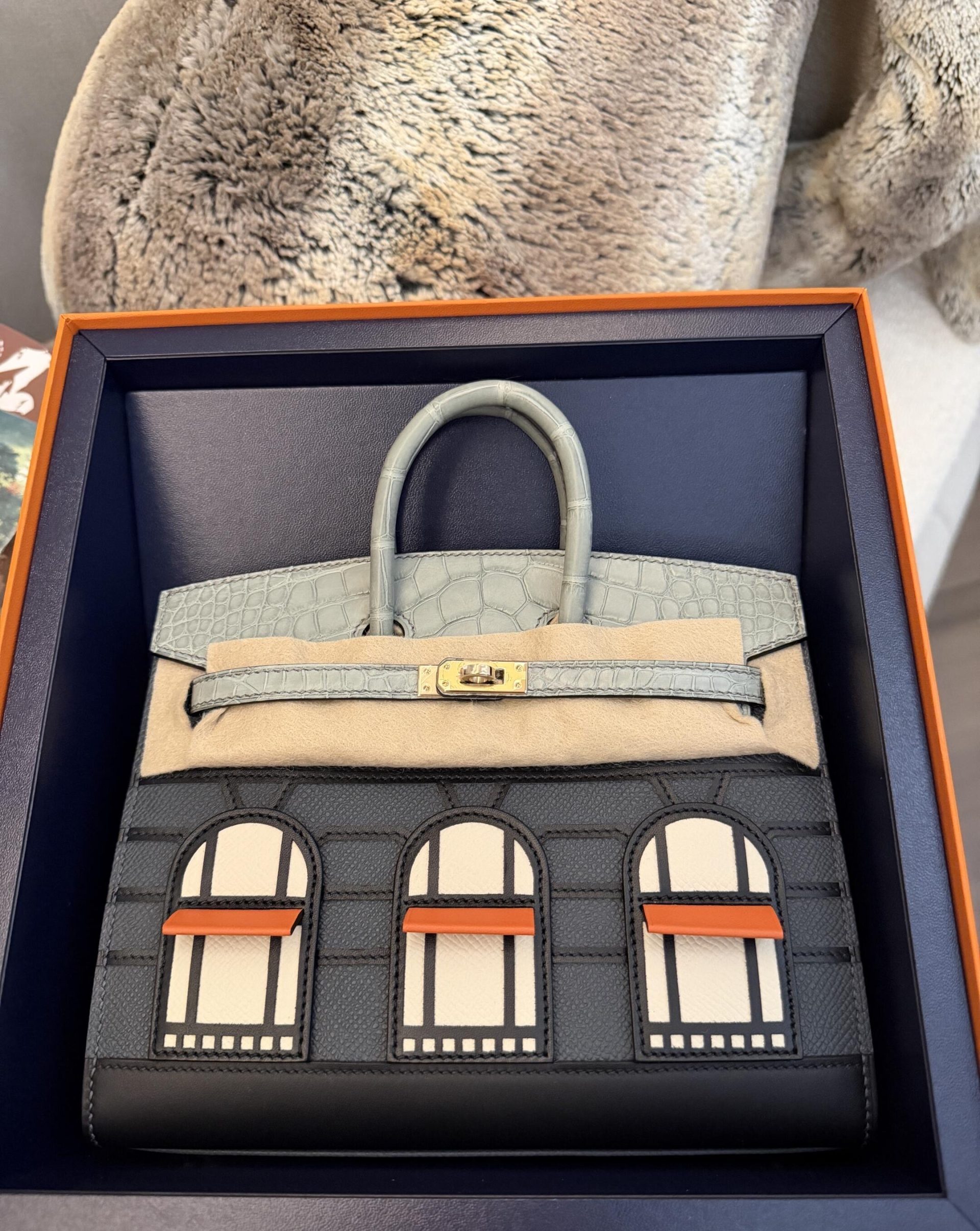 The stunning Faubourg Birkin house bag resting in its packaging.