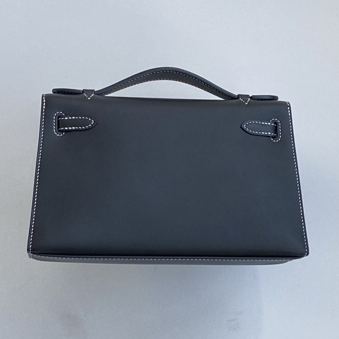 Back view of the bespoke Hermès Kelly clutch Pochette, showing the clean lines of the black Swift leather and smooth finish.