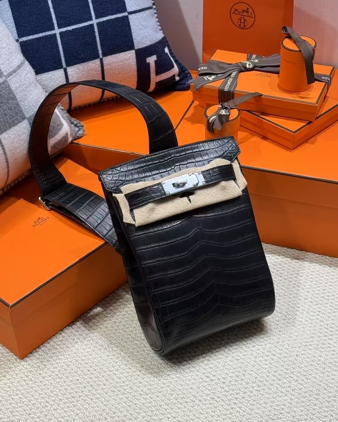 Full view of the Niloticus Crocodile HAC a Dos PM backpack with matching exotic leather shoulder strap and protective felt.