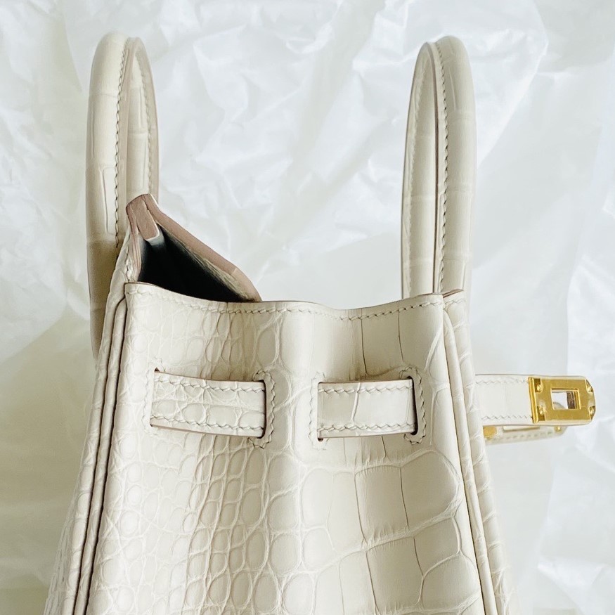 Detailed side profile of an alligator Birkin showing the clean edge painting and perfectly hand-punched sangles.